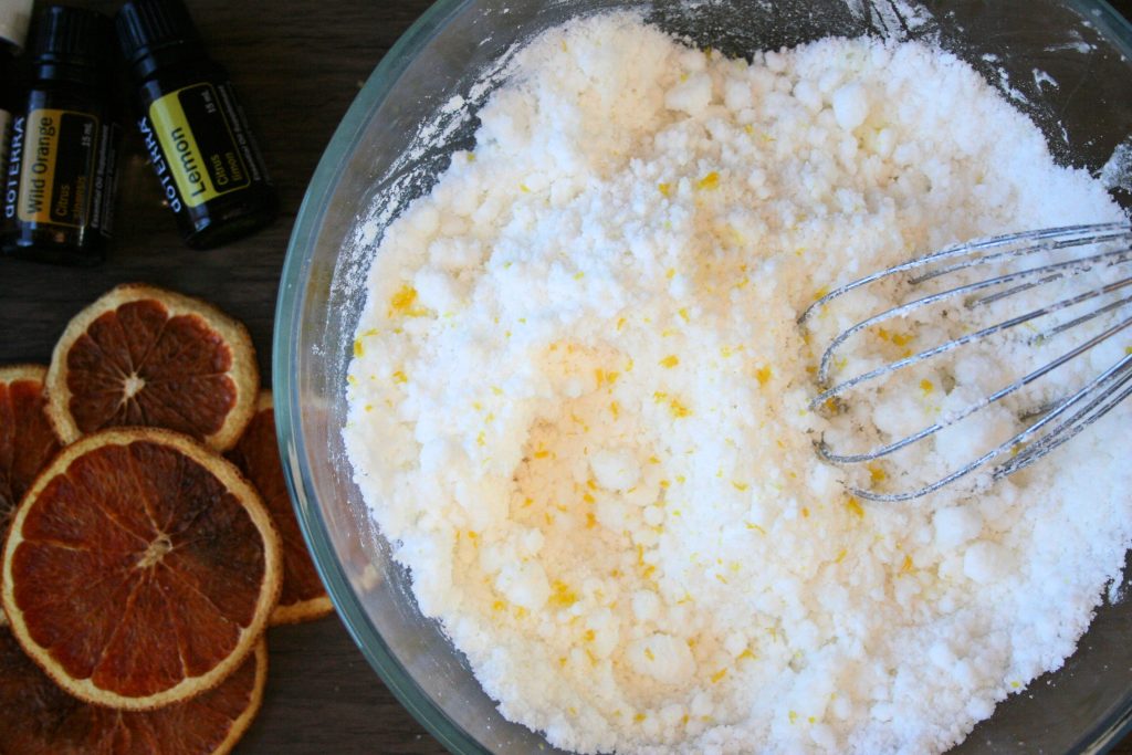 baking soda and sea salt and castile soap and citrus zest mixed together in a bowl