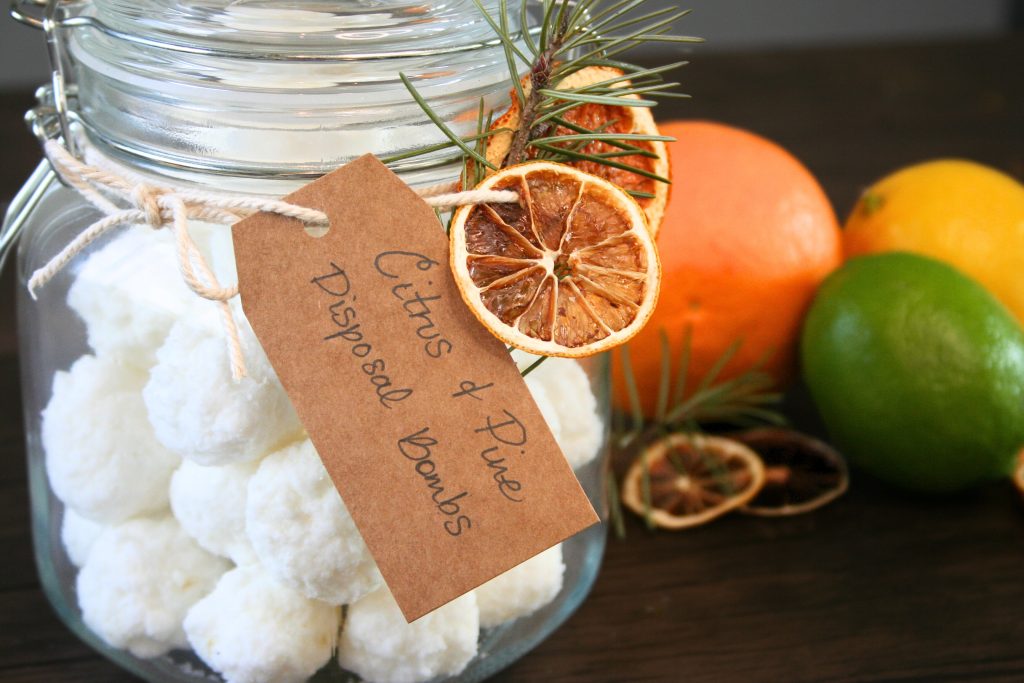 garbage disposal bombs inside of a glass jar with twine and dehydrated fruit around the jar